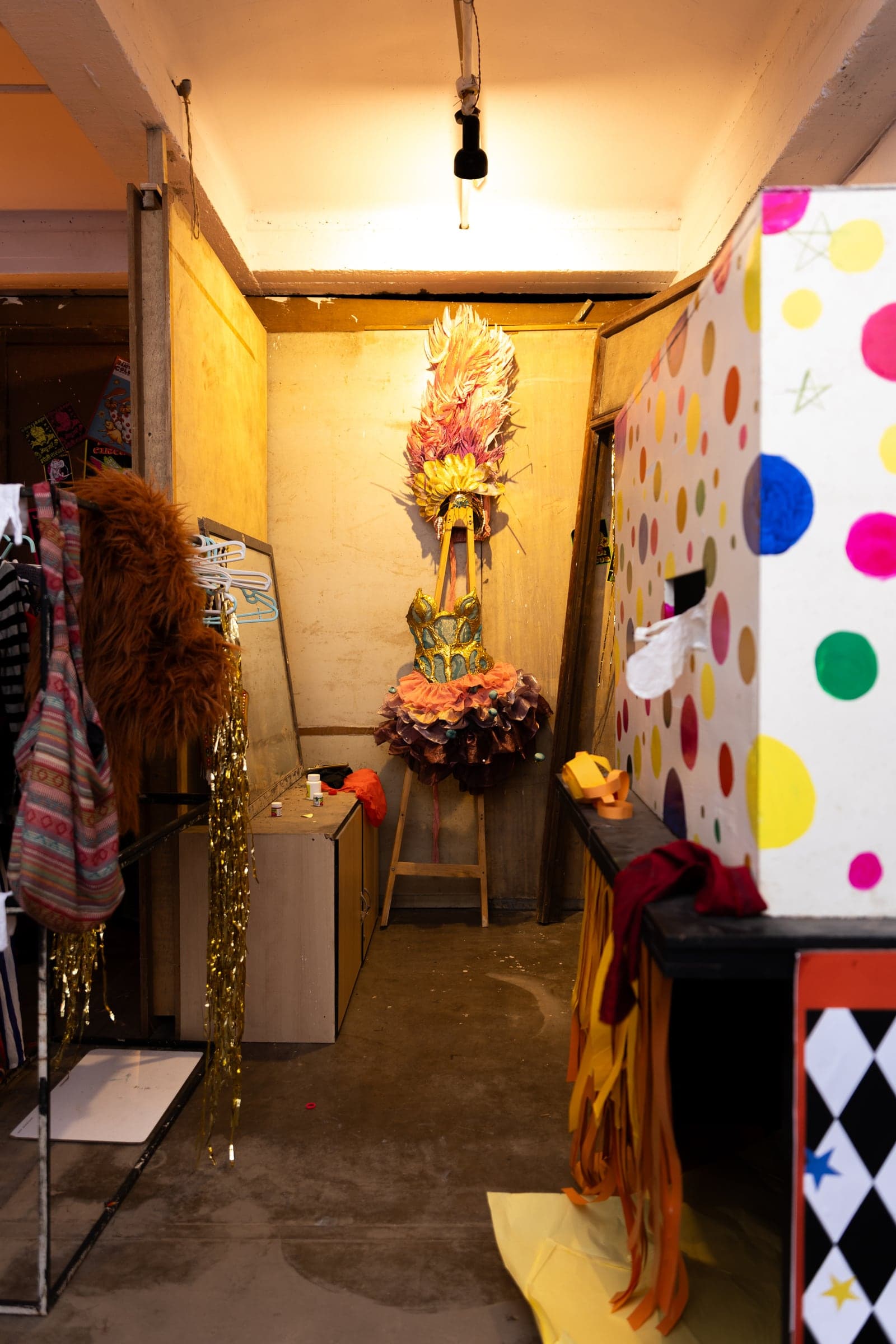 Feathered circus costume waiting inside the immersive set