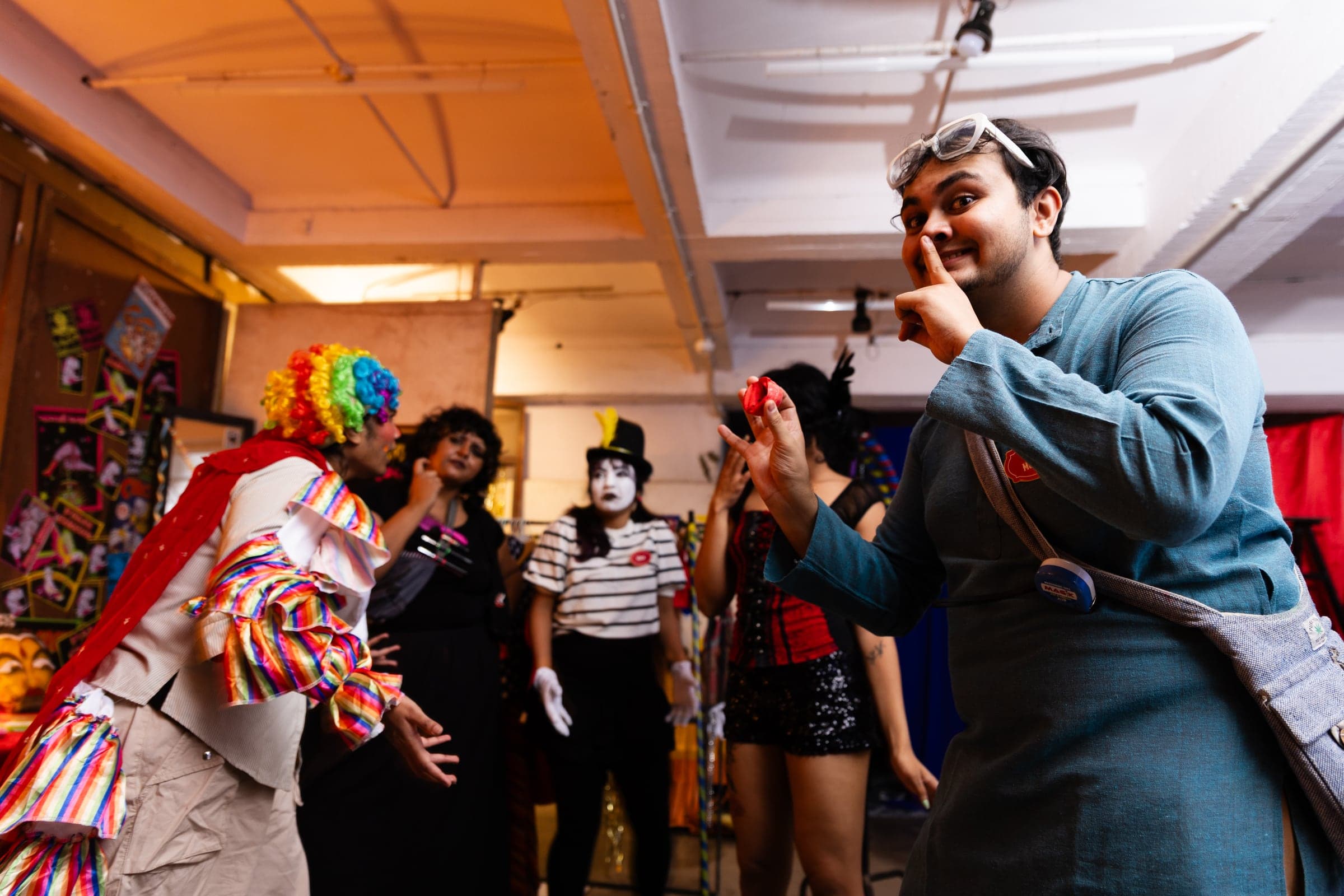 A visitor interacting with circus characters