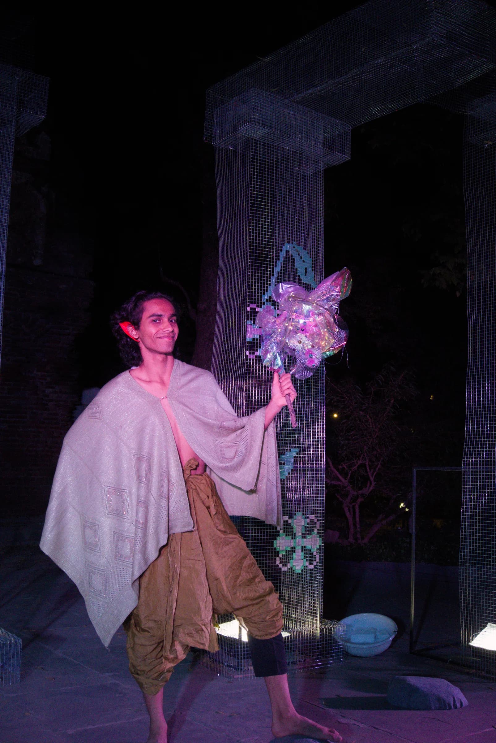 Botanical costume and flower prop under violet stage lighting