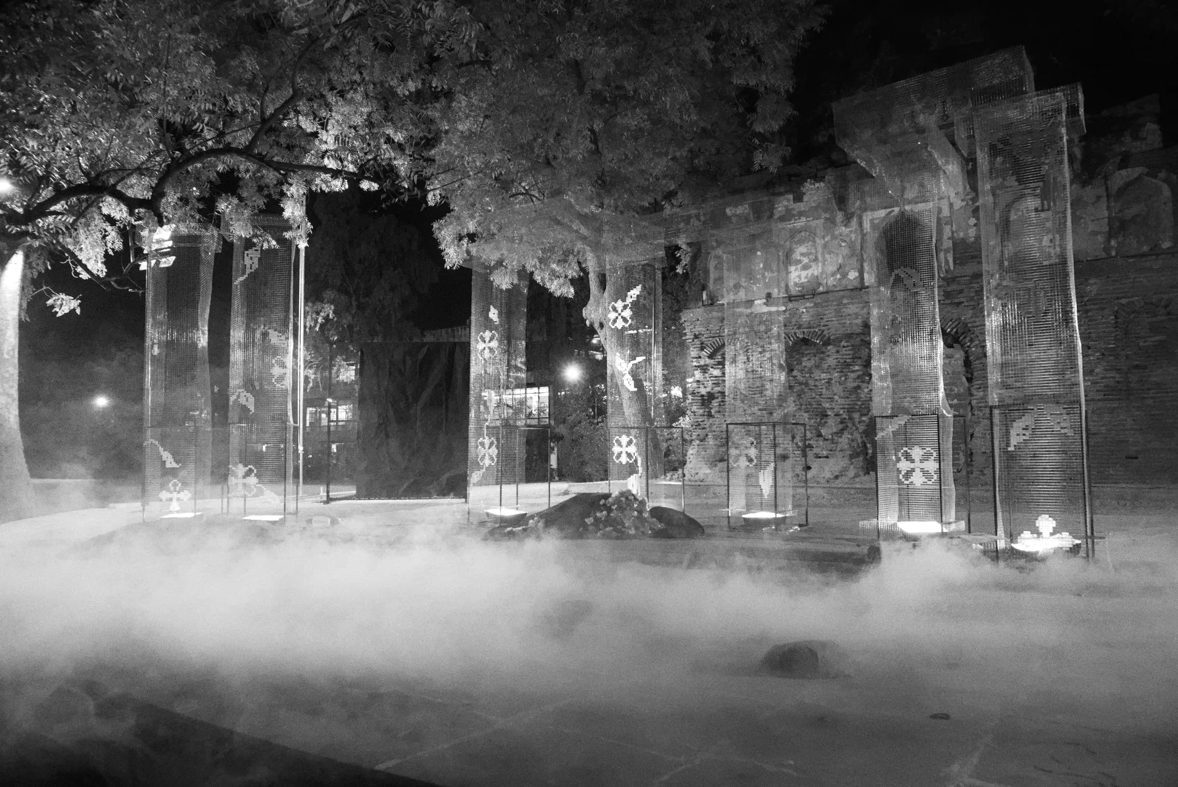 Black-and-white view of the outdoor set surrounded by fog and trees