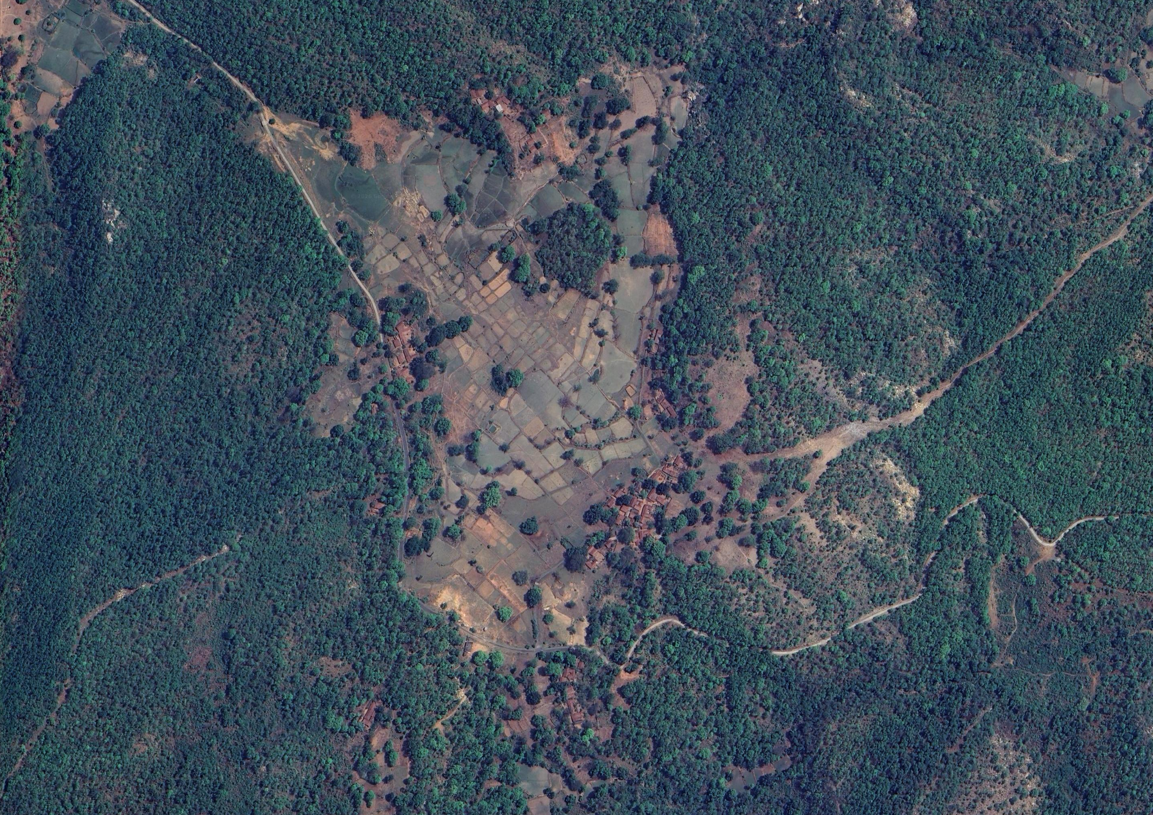 Aerial view of Netra Bera, with a clearing and settlement surrounded by forest