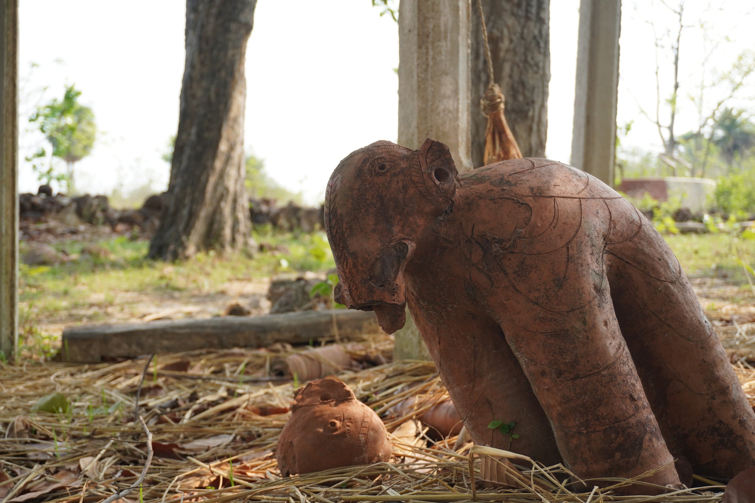 Clay figures beneath the trees