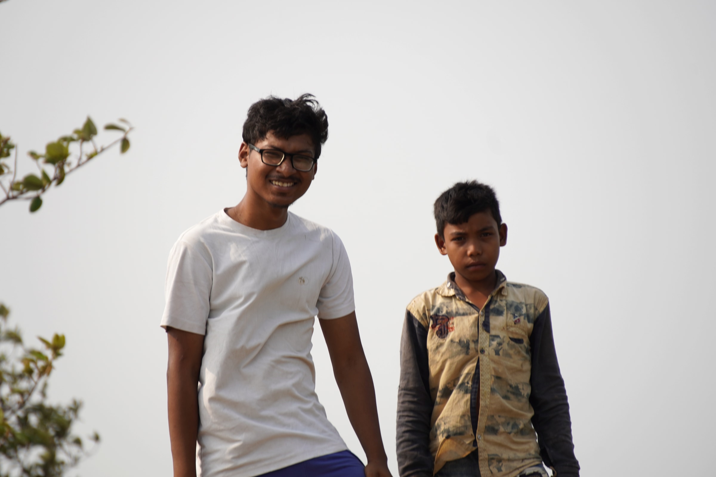 Two people photographed outdoors during field research in Ghatshila