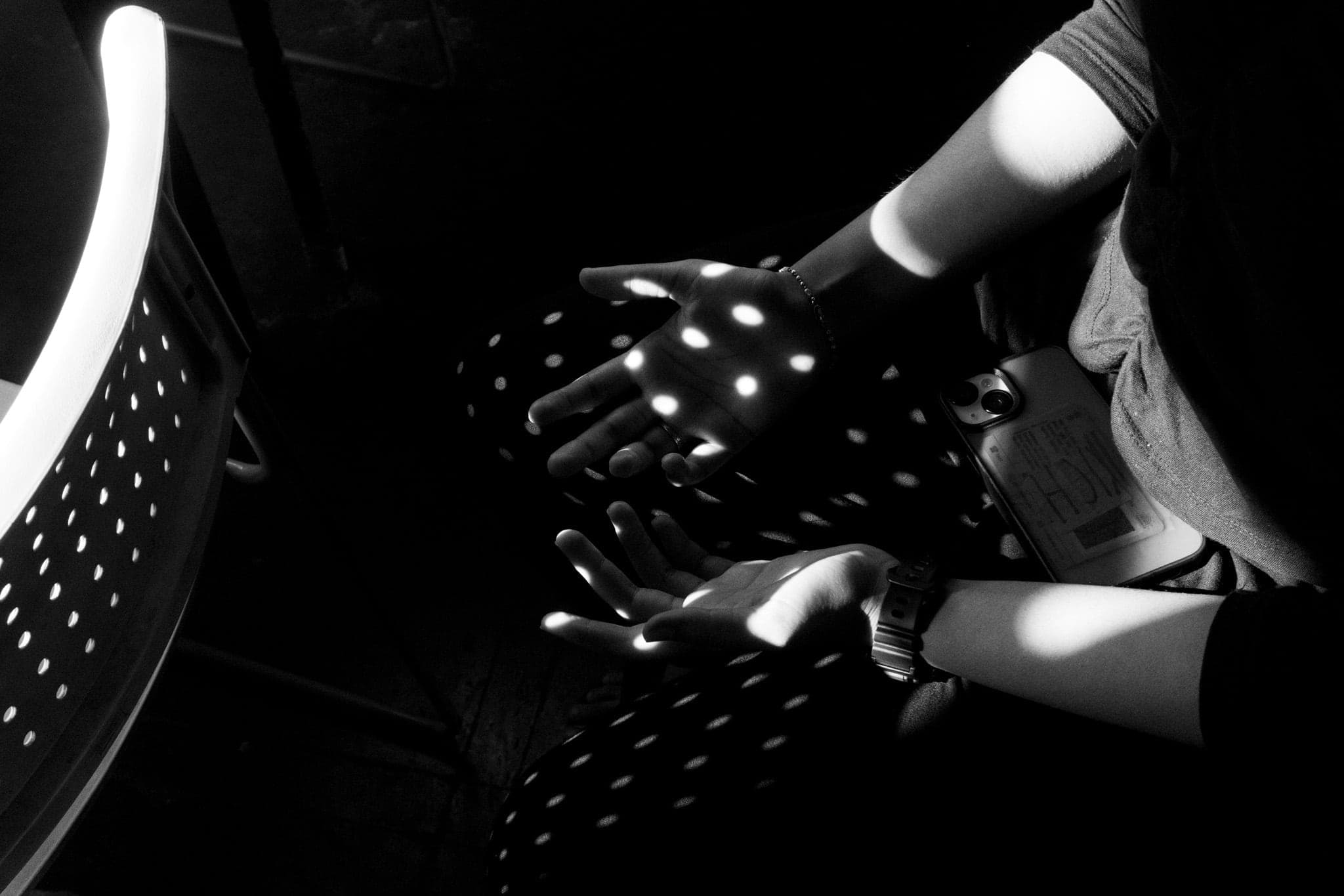 Spots of light falling across open hands