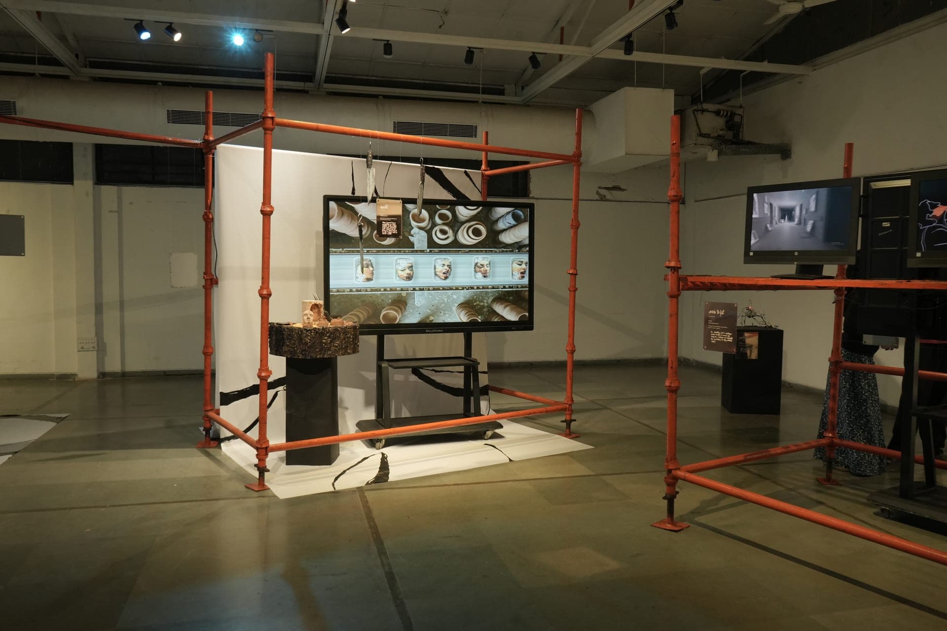 Screen mounted within the red scaffold structure