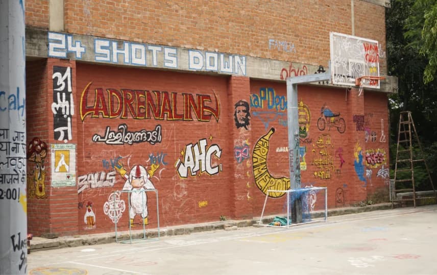 The wall of the basketball court at NID Ahmedabad next day after the “paint the BBC” event